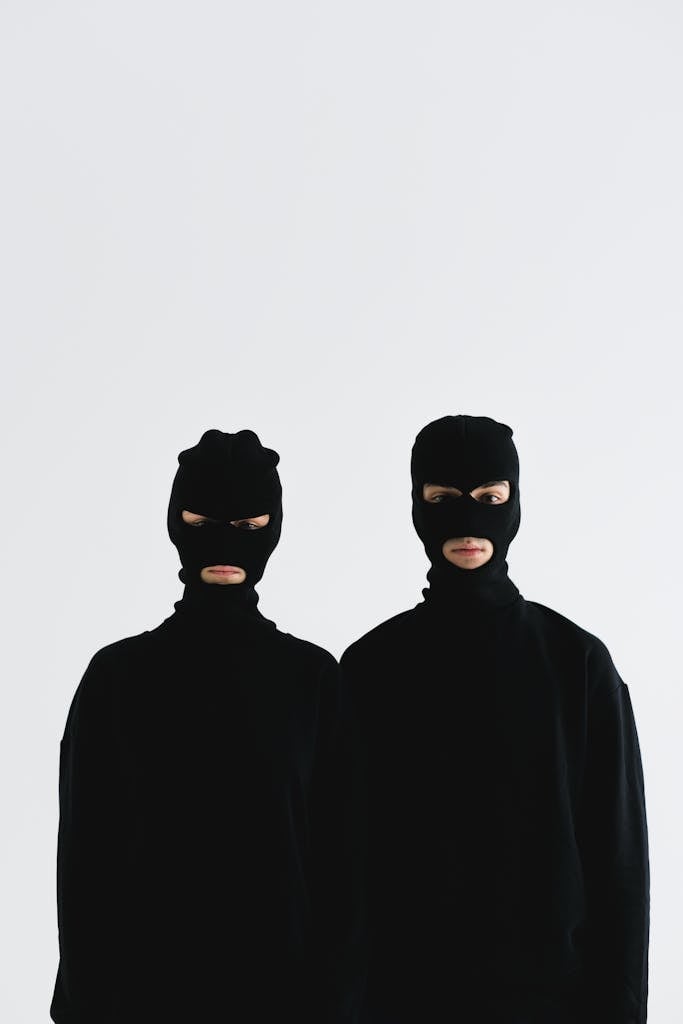 Close-Up Shot of Two People Wearing Robber Mask