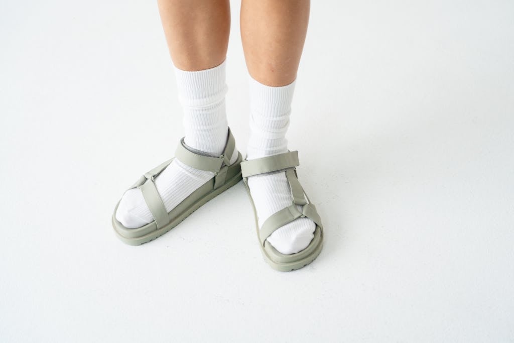 A Person Wearing White Socks and Sandals